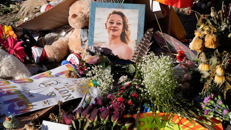 Flowers and photos are left at a memorial site for Renee Good on Saturday, Jan. 31, 2026, in...