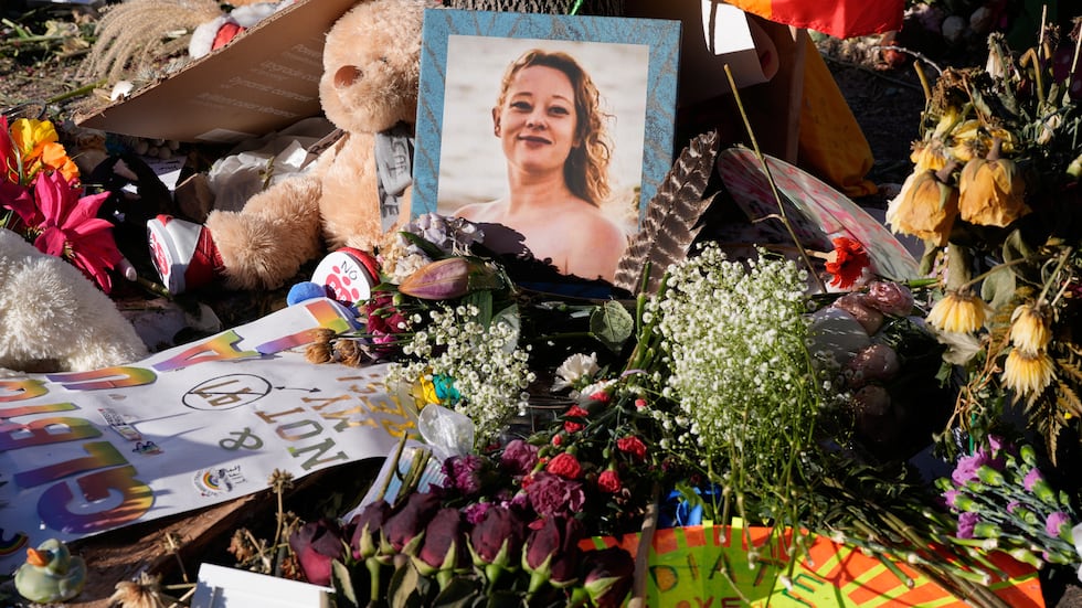 Flowers and photos are left at a memorial site for Renee Good on Saturday, Jan. 31, 2026, in...