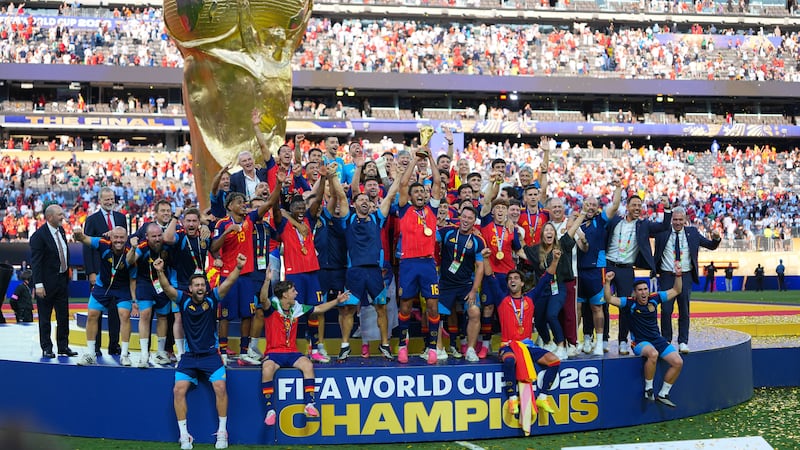 Spain's Rodri (16) lifts the trophy as the team celebrates winning the World Cup final soccer...