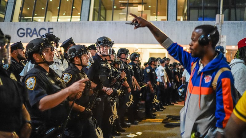 NYPD officers push New York Knicks fans back outside of a watch party in Bryant Park for Game...