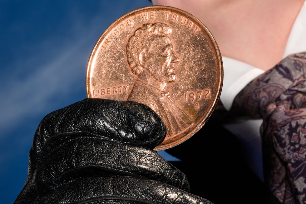 FILE - A person holds a giant penny at a mock funeral for the coin, Dec. 20, 2025, in front of...