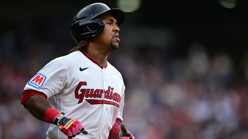 Cleveland Guardians' Jose Ramirez runs to first base after hitting a single during the third...