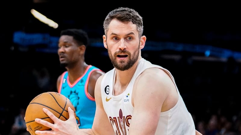 FILE - Cleveland Cavaliers' Kevin Love, foreground, controls the ball during an NBA basketball...