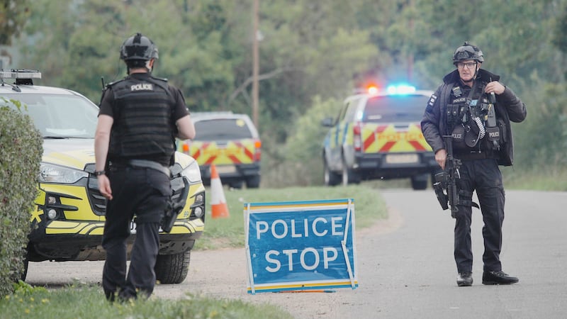 Police stand at a road block on the road to RAF Fairford after an incident, in Whelford,...