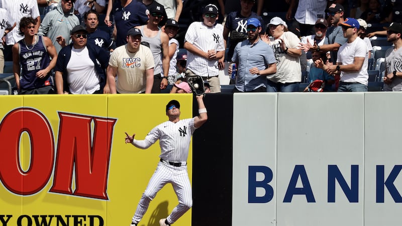 New York Yankees shortstop Max Schuemann makes a catch on a flyout by Cleveland Guardians'...