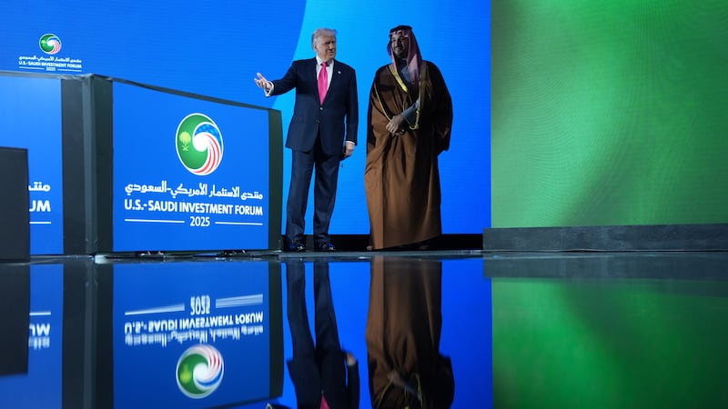 President Donald Trump walks on stage during the Saudi Investment Forum with Saudi Arabia's...