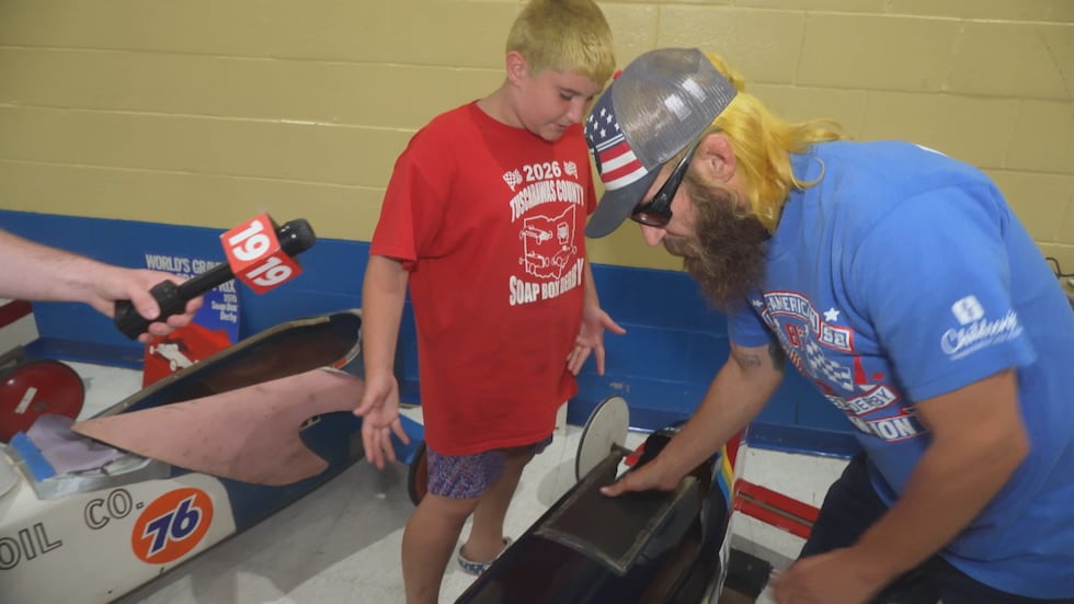 Blake and Jordan Witticker discuss one of their vintage soap box derby cars.