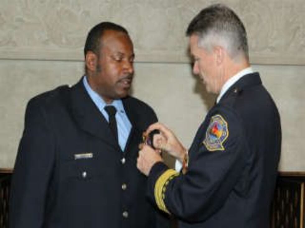 Lt. Walker (on left) at promotions ceremony in August 2013. (Source: WOIO)