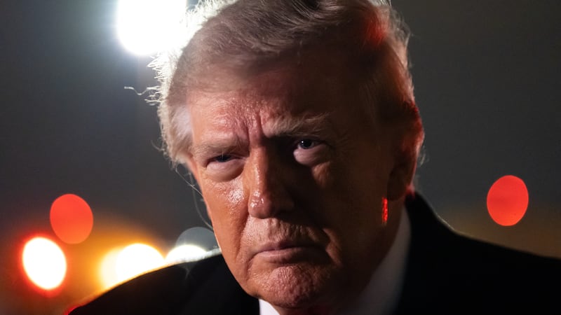 President Donald Trump speaks with reporters as he arrives on Air Force One, Saturday, Oct....