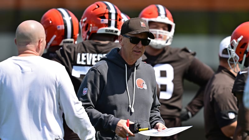 Cleveland Browns head coach Todd Monken walks away from a huddle during NFL football practice,...