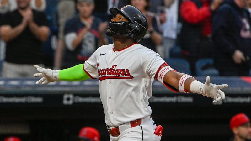 Cleveland Guardians' Angel Martinez reacts after hitting a two-run home run off Athletics...