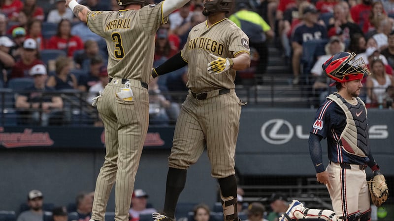 San Diego Padres' Jackson Merrill (3) congratulates Xander Bogaerts, center, after Bogaerts...
