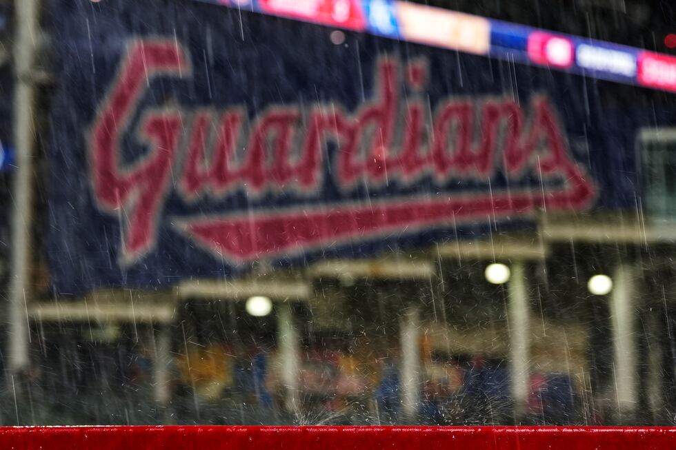 Rain bounces off a railing at Progressive Field during a rain delay in the fifth inning of a...