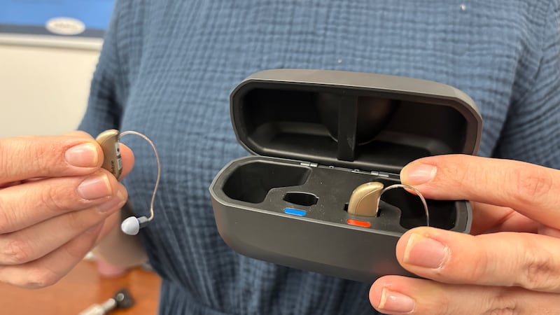 Audiologist Lauren Roll holds the Beltone Envision 360 A.I. hearing aid