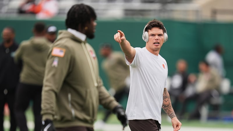 Cleveland Browns quarterback Dillon Gabriel, right, warms up before an NFL football game...