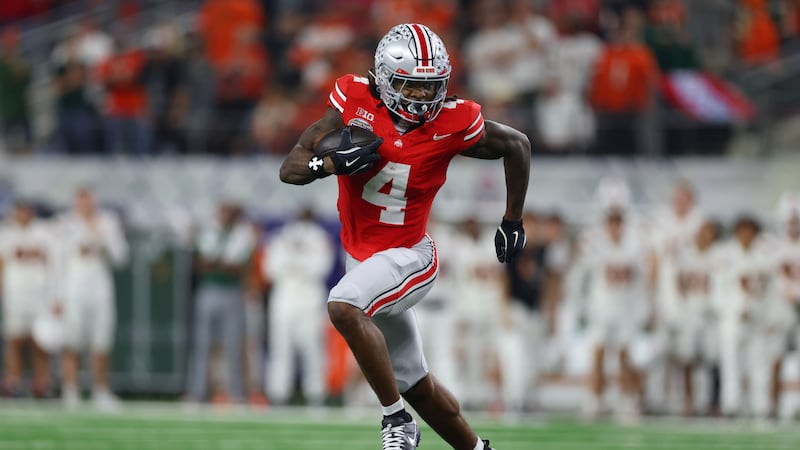 Ohio State wide receiver Jeremiah Smith runs the ball against Miami during the second half of...